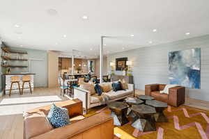 Living room featuring wood finished floors, wood walls, and recessed lighting