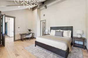 Bedroom with light wood-style flooring, high vaulted ceiling, and beamed ceiling