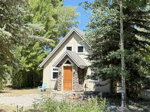 View of front of home with stone siding and board and batten siding