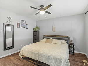 Bedroom with dark wood finished floors and ceiling fan