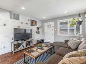 Living room featuring wood finished floors, recessed lighting, and wood walls