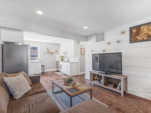 Living area featuring hardwood / wood-style flooring and recessed lighting