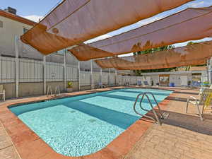 Community pool featuring a patio