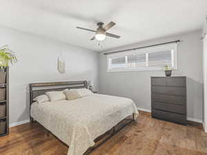 Bedroom featuring wood finished floors and a ceiling fan
