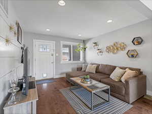 Living area with dark wood-style floors and recessed lighting