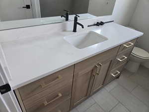 Bathroom with vanity and tile patterned flooring