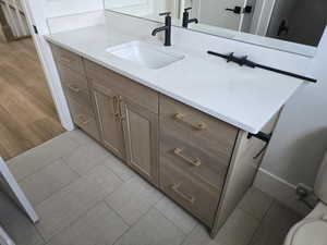 Bathroom featuring vanity and wood finished floors