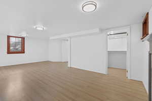 Below grade area featuring light wood-style floors and baseboards