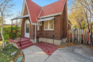 View of front of property with brick siding and a shingled roof