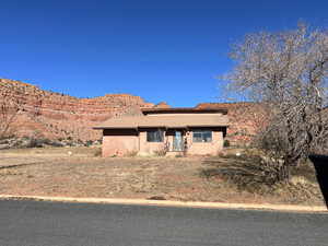 Single story home with a tiled roof, stucco siding, and a mountain view