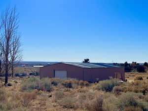 View of pole building with a rural view