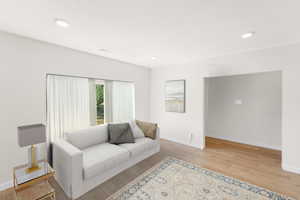 Full-size living room with brand new laminate flooring and large bay window. Let’s in the natural light and beautiful outdoor views