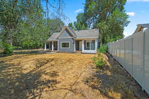 The outside features newly-poured sidewalks, 2 covered patios, outbuildings and plenty of parking space. The yard has space to play with large mature trees providing lots of shade