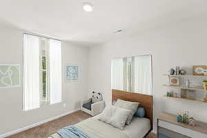 Fully carpeted spacious bedroom featuring 2 windows for lots of natural lighting