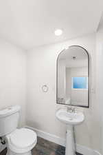 Fully renovated bathroom featuring tub/shower with tub to ceiling ceramic tile, pedestal sink and large modern mirror. Lots of space for linen storage