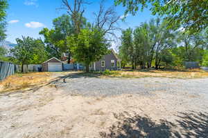 The outside features newly-poured sidewalks, 2 covered patios, outbuildings and plenty of parking space. The yard has space to play with large mature trees providing lots of shadestructure