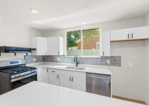 Kitchen featuring brand new white cabinets, quartz countertops, large island with bar for seating, laminate flooring and stainless steel appliances. Kitchen also features a large sized pantry