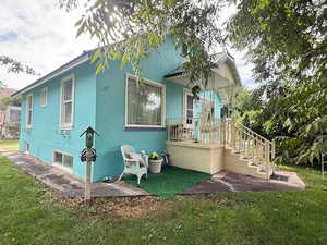 View of home's exterior featuring a yard and stucco siding