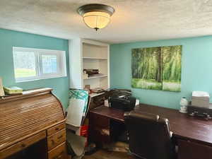 Office featuring a textured ceiling and wood finished floors