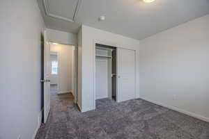 Unfurnished bedroom with carpet flooring and a closet