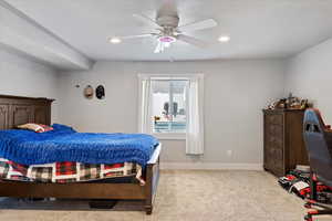 Bedroom with light carpet, recessed lighting, and a ceiling fan