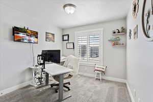 Carpeted office with baseboards