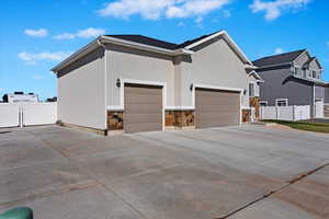 View of side of home with RV parking, driveway, and a garage