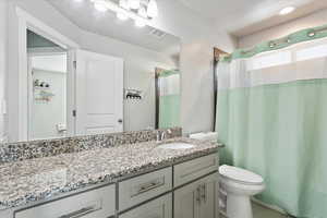 Full bathroom with vanity and curtained shower