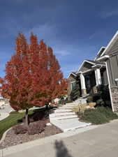 View of side of property featuring stone siding