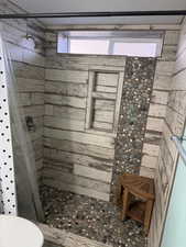 Bathroom featuring a stall shower and toilet