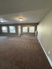 Empty room featuring carpet flooring