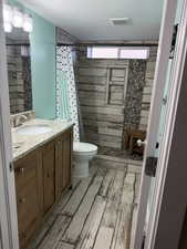 Bathroom featuring vanity, a shower stall, and light wood-type flooring