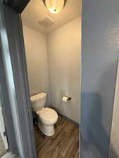 Bathroom featuring a textured ceiling and dark wood-type flooring