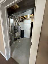 Unfinished below grade area with secured water heater and heating unit