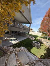 Back of house with an outdoor fire pit and a patio area