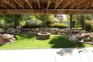 View of yard featuring a fire pit and a patio area