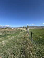 View of yard with a rural view and a mountain view