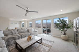Carpeted living room featuring a mountain view, healthy amount of natural light, recessed lighting, and ceiling fan