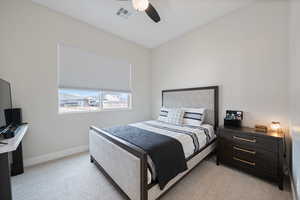 Bedroom featuring light colored carpet and a ceiling fan