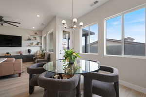 Dining space with light wood finished floors, recessed lighting, and a chandelier