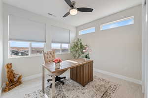 Office with light colored carpet, plenty of natural light, and ceiling fan