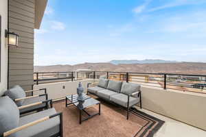 Balcony featuring a mountain view and an outdoor living space