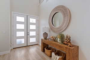 Foyer entrance featuring light wood finished floors and baseboards