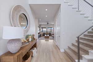 Entrance foyer featuring stairway, light wood finished floors, recessed lighting, and a ceiling fan