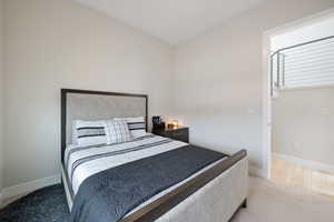 Bedroom with baseboards and carpet