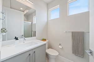 Bathroom with vanity and a shower with door