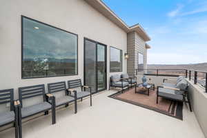 Patio / terrace with an outdoor hangout area and a mountain view