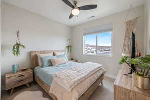 Carpeted bedroom with baseboards and ceiling fan
