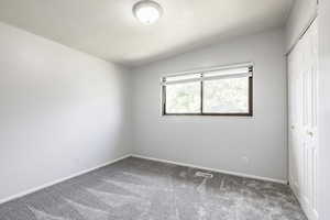 Unfurnished bedroom featuring carpet floors and a closet