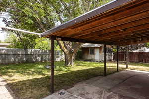 Fenced backyard with a shed and a patio area